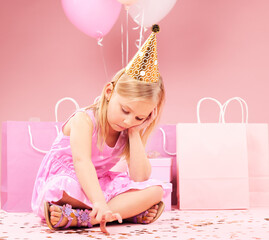 Depression, sad birthday and child on pink background disappointed for party, celebration and...