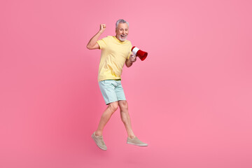 Full size body photo of crazy jumping beach announce news bullhorn sell tourists cheap fast food isolated on pink color background