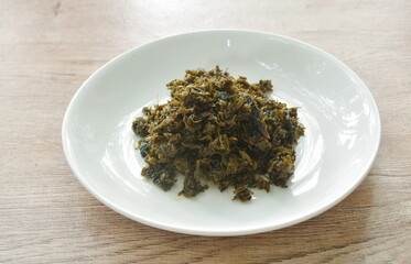 stir fried pickled mustard or Gan Lan Cai Chinese food made from cabbage and black olive in oil on plate