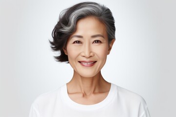 Fototapeta premium Optimistic middle-aged asian female looking at camera, smiling feels happy. Positive emotion concept