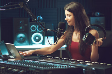 Young woman working in the recording studio - obrazy, fototapety, plakaty
