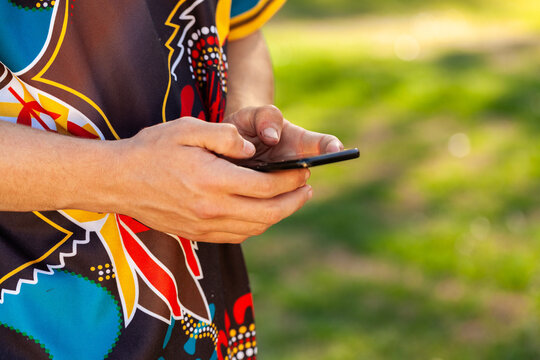 Aboriginal teenager using mobile phone to text message