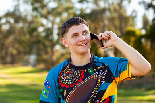Aboriginal teenager using mobile phone to talk with mates