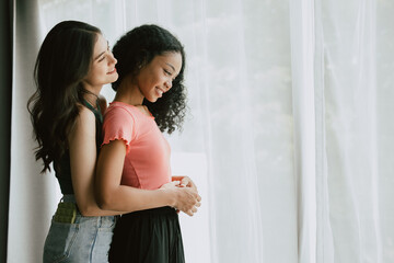 Women lover LGBTQ friend living together hands embrace at waist mix skin color