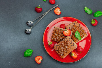 Delicious chocolate cakes with fresh strawberries. Sweet dessert, good morning concept