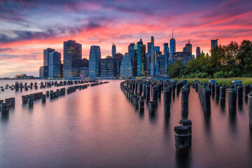 Sunset over lower Manhattan as seen from Brooklyn Bridge Park, New York City.