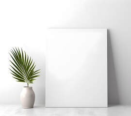 Mock-up frame on the white wall with tropical leaf in vase