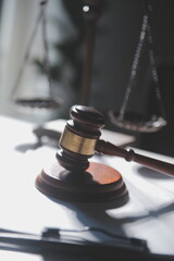 Business and lawyers discussing contract papers with brass scale on desk in office. Law, legal...