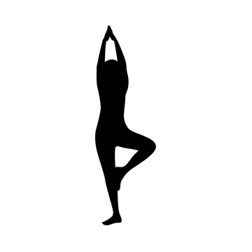 Silhouette of woman standing in yoga pose
