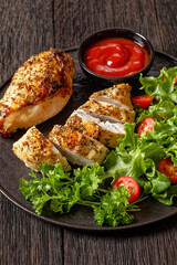 Baked Split Chicken Breasts with salad on plate
