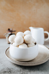 Beautiful and delicious homemade coconut flakes truffles with almonds and nuts in a retro grunge style.