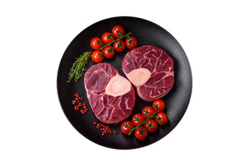 Fresh raw beef steak with bone or ossobuco with salt, spices and herbs