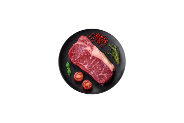Fresh raw beef striploin steak with salt, spices and herbs