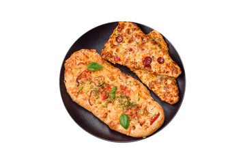Delicious oven fresh flatbread pizza with cheese, tomatoes, sausage, salt and spices
