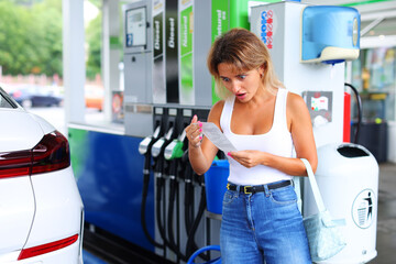 woman at gas station shocked by fuel price