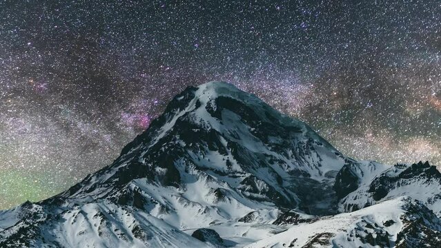 Beautiful night Timelapse landscape, snow covered mountains in the starry night.
