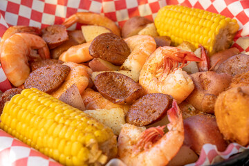 Low Country Boil.Traditional Dish with Shrimp,Saussage,Potatoes,Corn and Hush Puppies.Savannah,Georgia,.United States of America