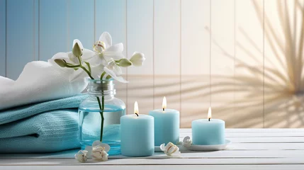 Photo sur Plexiglas Salon de massage Spa salon light blue composition in wellness center. Spa still life background with aromatic candle, orchid flower and towel. Beauty spa treatment and relax. Relaxing background.