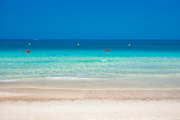 Sandy beach on the seashore with clear turquoise water