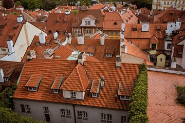 Fototapeta na wymiar Top view to red roofs skyline of Prague city, Czech Republic. Aerial view of Prague city with terracotta roof tiles, Prague, Czechia. Old Town architecture with terracotta roofs in Prague