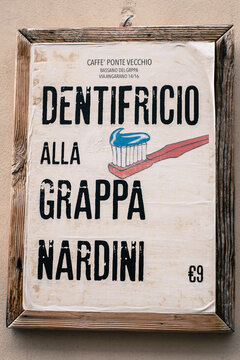 Old advertising sign that says "toothpaste with Grappa Nardini" in Bassano del Grappa, Italy