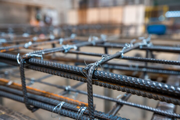 Steel rods or bars used to reinforce concrete, in warehouse at the metalworking shop. Modern...