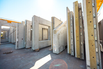Precast concrete wall panels in factory to transport and install