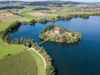 Aerial view of the Mauern Lake with an old, little castle on the small island