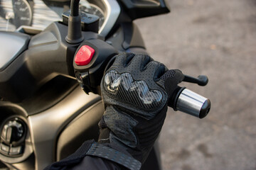Close-up of a motorcyclist's hand speeding with his motorcycle. Speed and dangerous driving concept.