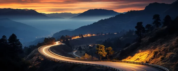 Papier Peint photo Autocollant Autoroute dans la nuit As dusk fell, lights and vehicle traces from cars and trucks could be seen circling along a mountain road between circular ravines..