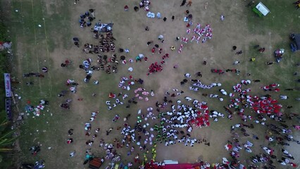 Gorontalo, Indonesia - August 17 2023: Aerial view of Indonesian flag lowering ceremony witnessed by villagers. Indonesia Independence Day
