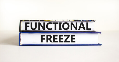 Functional freeze symbol. Concept words Functional freeze on beautiful books. Beautiful white table white background. Business psychology functional freeze concept. Copy space.