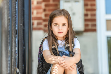Fototapeta premium student girl wearing school backpack outside of the school