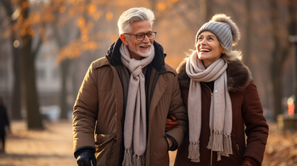 Elderly couple in winter park, happily enjoying nature.
