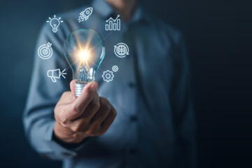 business, document, management, file, search, solution, light bulb, target, network, process. close up to hand, hold light bulb to light up solution and advertise to hit the goal and target.