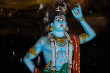 a lord krishna lifting a mountain on his finger sculpture