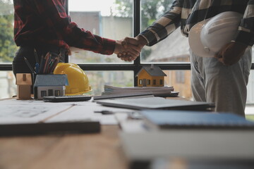 Happy workers at construction site, young civil engineer manager and architects handshaking at...