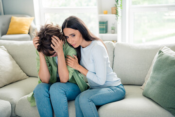Obraz premium Photo of supportive girl sit couch embrace comforting depressed desperate friend bright flat indoors