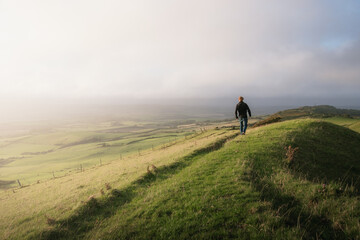 Fototapeta na wymiar A man exploring a mountainside with a mazing views