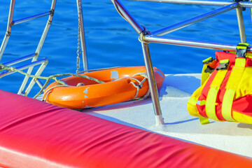 Plastic lifebuoy and life jacket on board a pleasure yacht