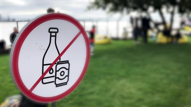Sign Drinking alcoholic beverages is prohibited on the park lawn for recreation .A public place. in the background is a child, garbage utilization. The concept of a healthy lifestyle