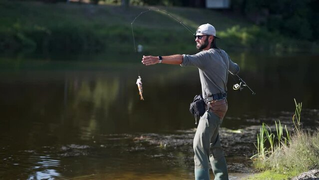 Angler ultralight catching pike . Fisher pilling perch 	