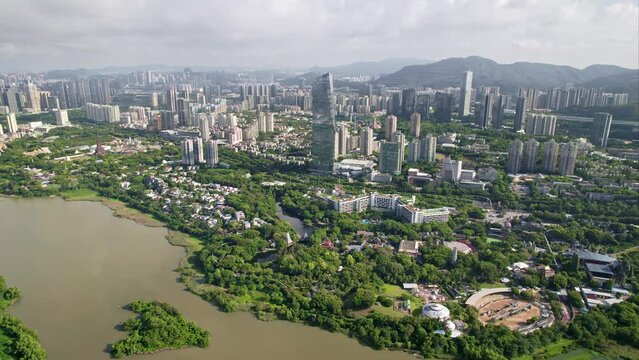 Drone flight above Shenzhen city megapolis, China's innovative, technology hub.
Aerial footage of the financial centre modern metropolis surrounded by beautiful green hills