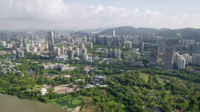 Drone flight above Shenzhen city megapolis, China's innovative, technology hub.
Aerial footage of the financial centre modern metropolis surrounded by beautiful green hills