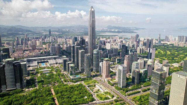 Drone flight above Shenzhen city metropolis, China's innovative, technology hub.
Aerial footage of the modern skyscrapers including Ping An   finance center surrounded by beautiful green hills