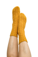Female legs in yellow hand knitted wool socks