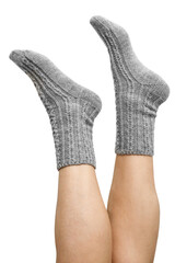 Female legs in grey hand knitted wool socks