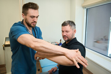Qualified physical therapist performing manual muscle strength testing