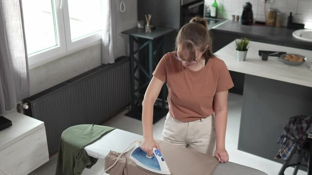 one woman ironing clothes at home hold iron household chores concept
