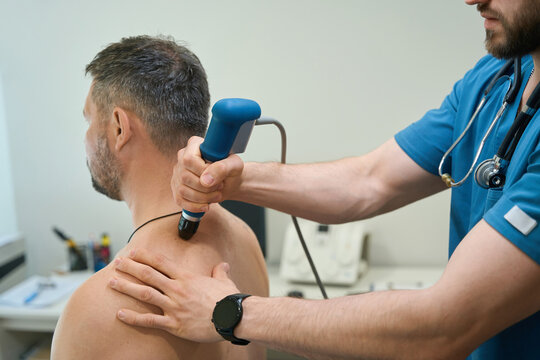 Patient being treated for dorsodynia by physical therapist in clinic